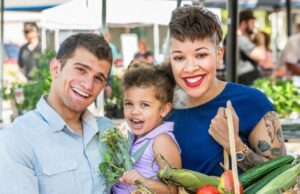 Family shopping at a farmers market.